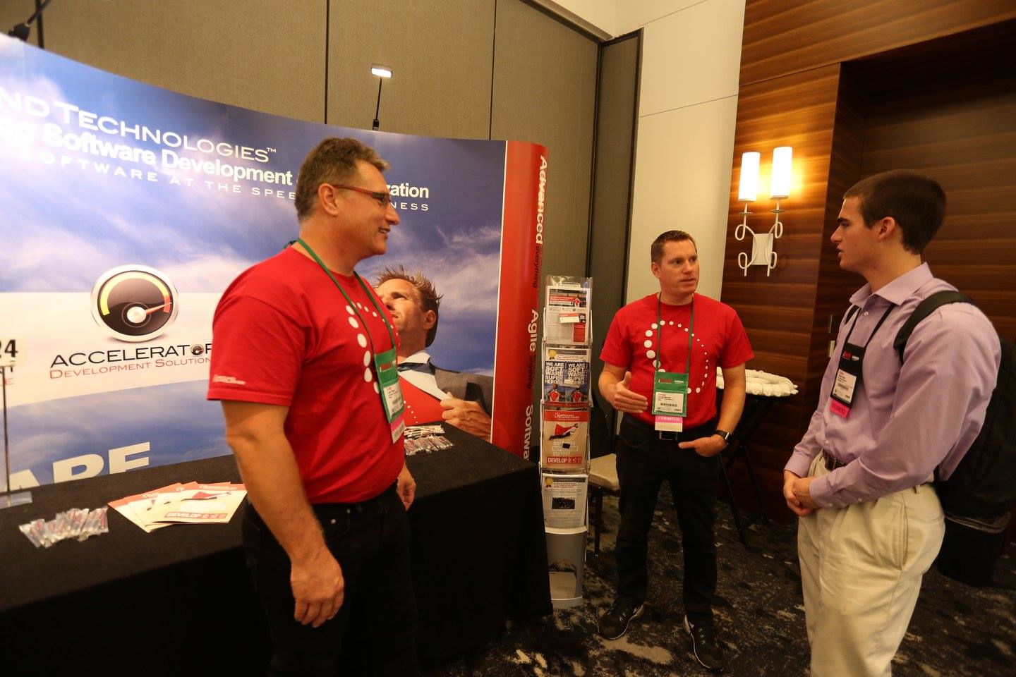 Lee and Derek talk with an attendee at the conference expo.
